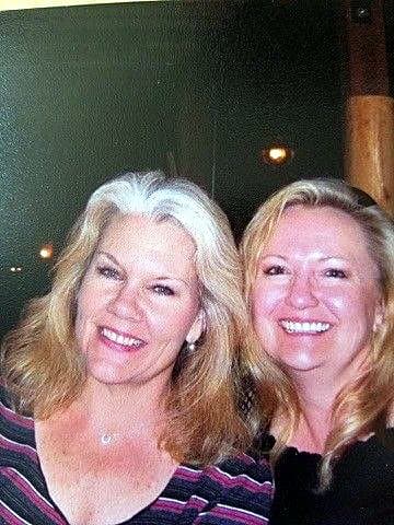 Eve Hess, smiling with grey hair, cheek to cheek with her friend Phyllis
